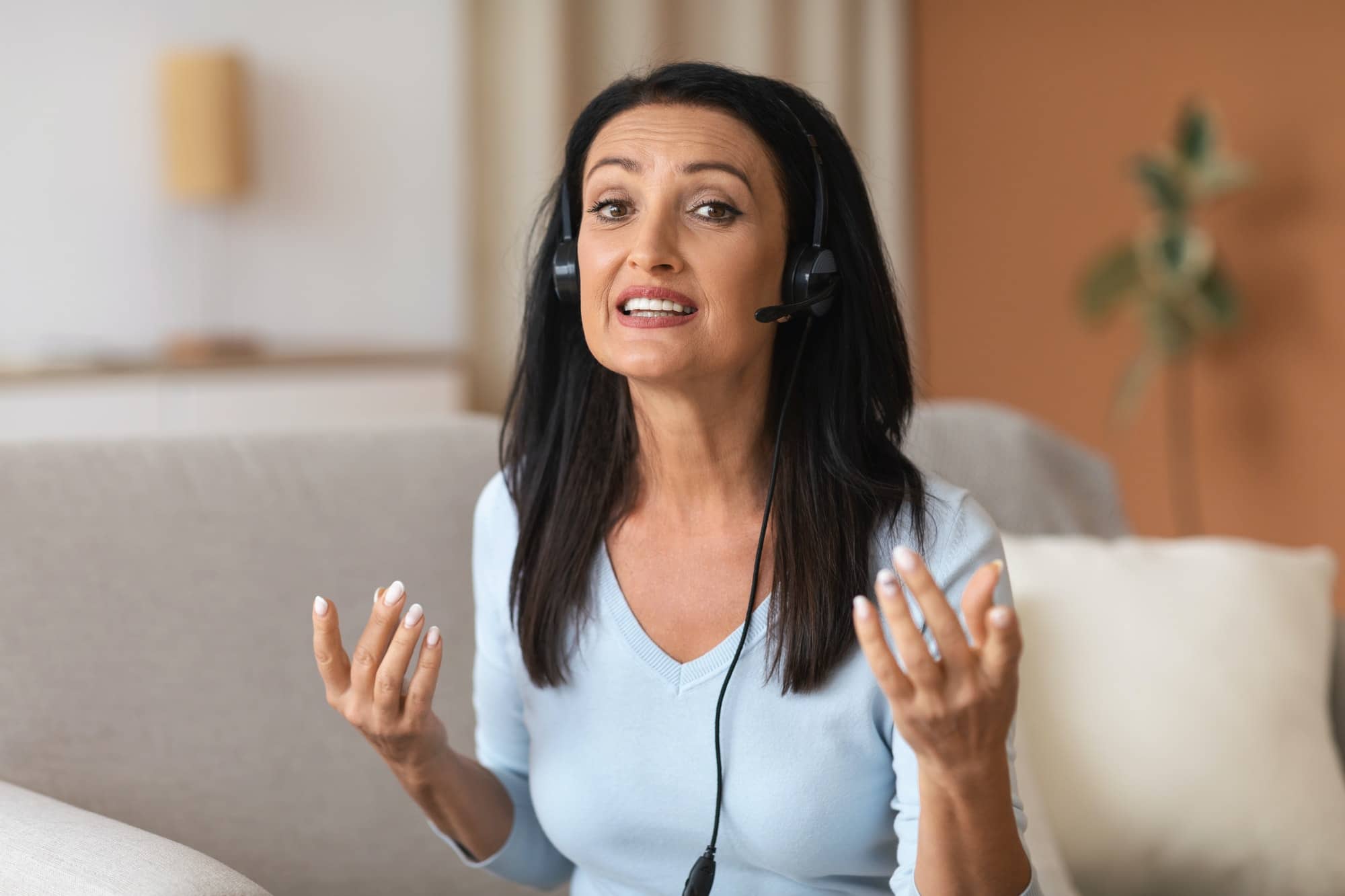 Mature Woman Wearing Headset Having Virtual Video Call