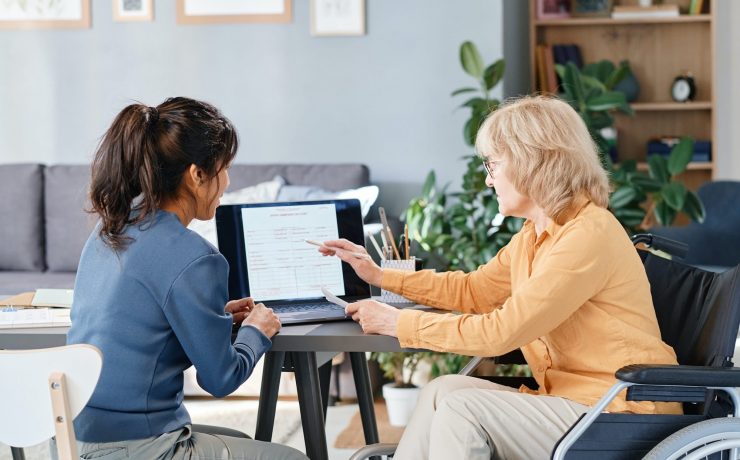 Elderly woman learning the new business with assistant